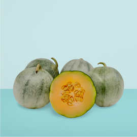 Several ripe Charentais melons with one cut in half, displaying the inside with seeds and flesh, against a two-tone blue background.
