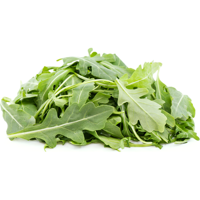 Pile of fresh green arugula leaves on a white background