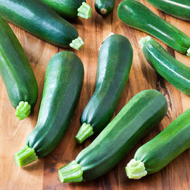 Green zucchinis on a wooden surface