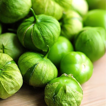 Close-up of green tomatillos on a wooden surface